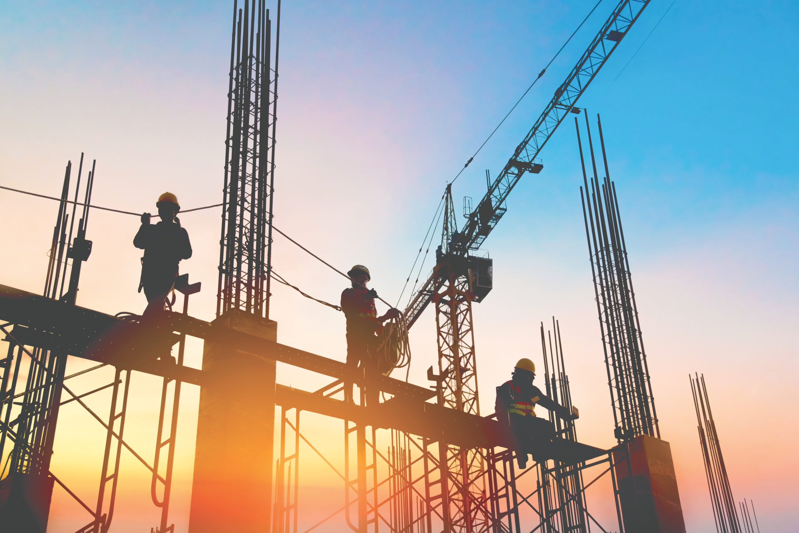 silhouette construction worker Concrete pouring during commercial concreting floors of building in construction site and Civil Engineer inspection work