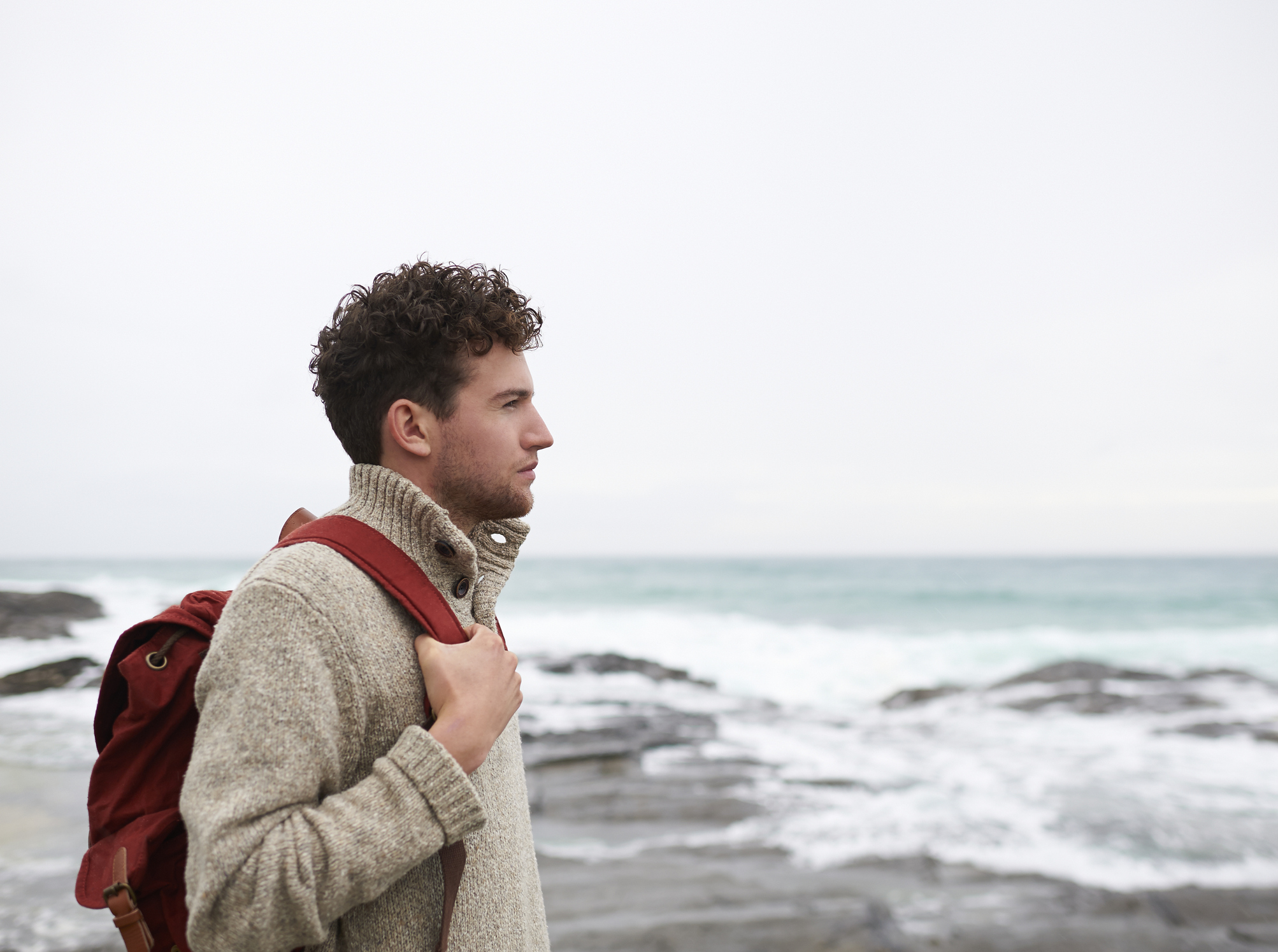 Profile of man on UK coastline.