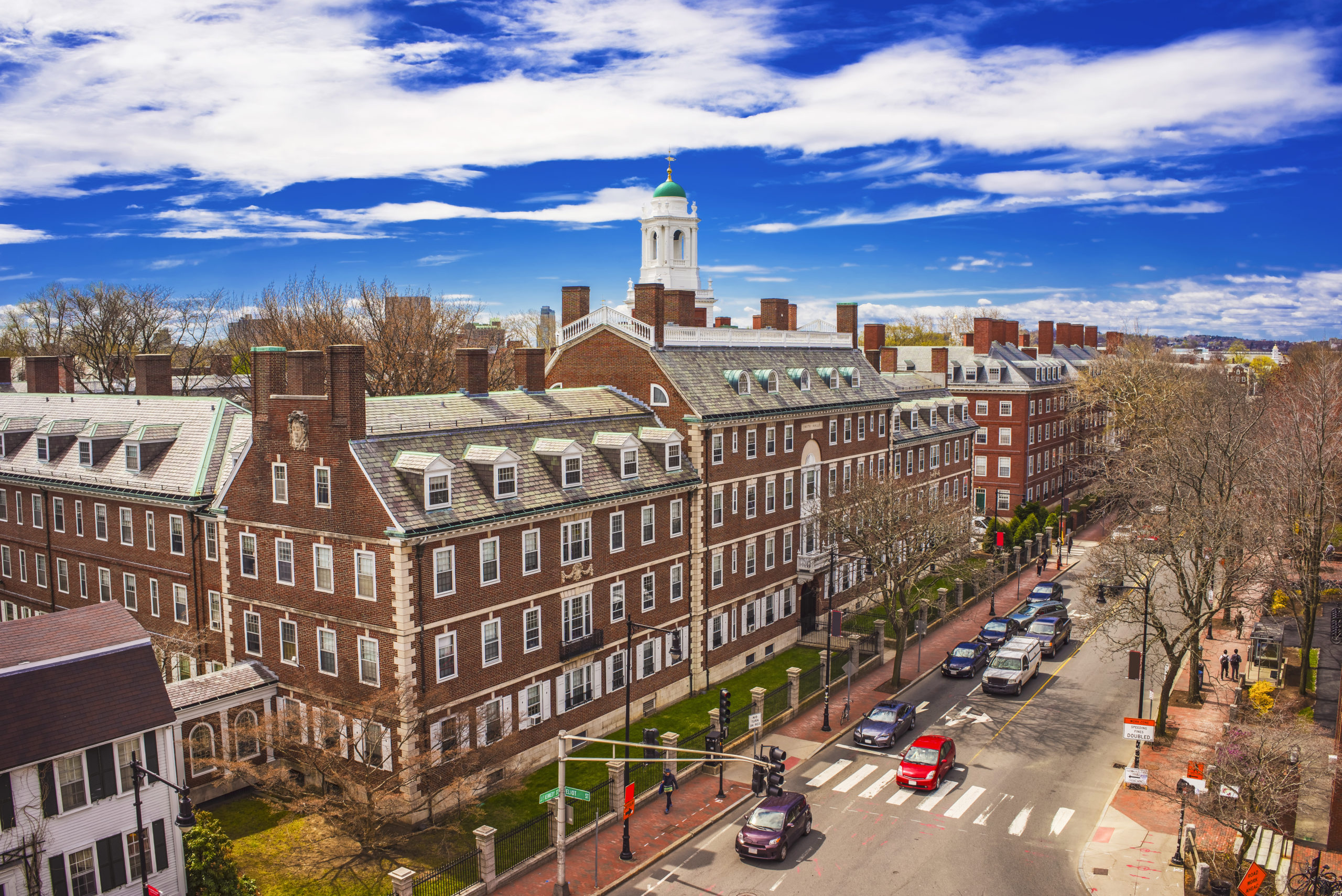 Aerial view on John Kennedy Street in the Harvard University Area in Cambridge, Massachusetts, the USA. Eliot House white belltower seen on the background. Tourists in the street.