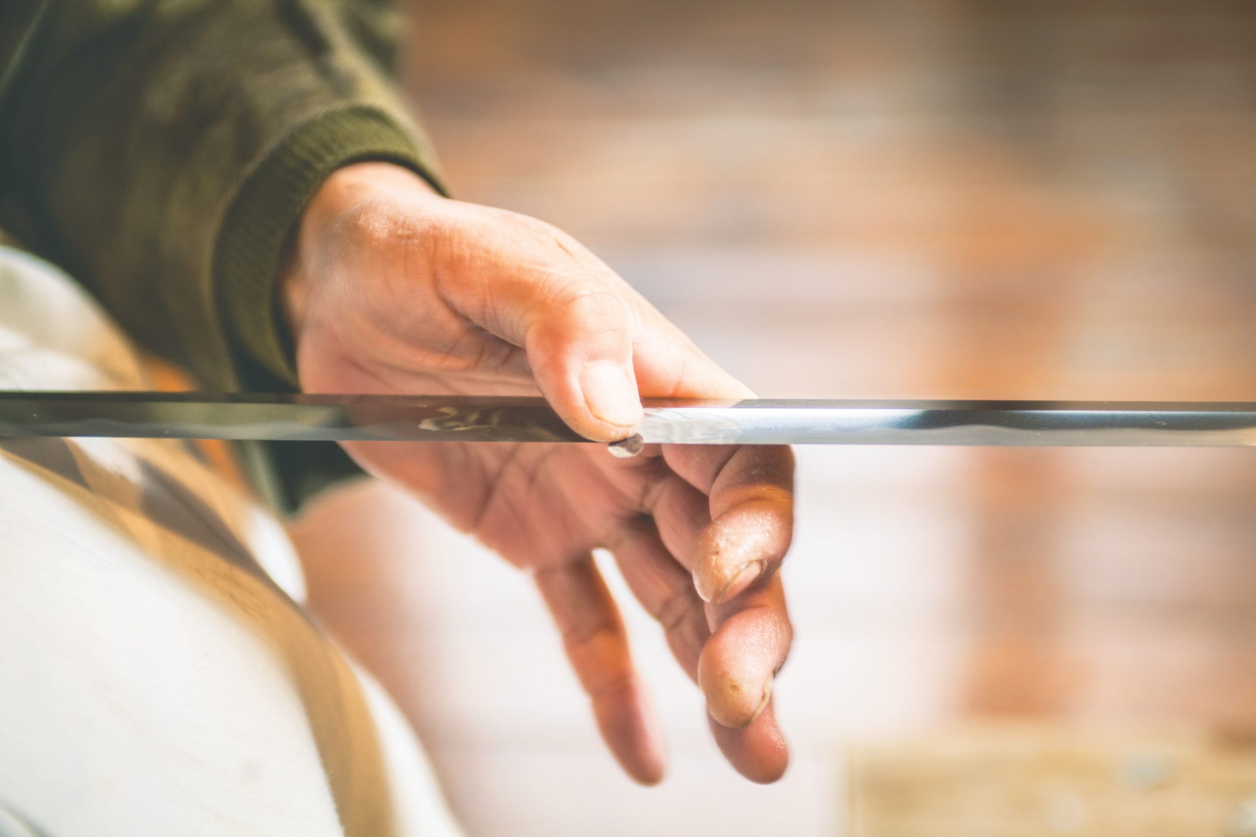 A craftsmen sharpens a traditional Japanese sword