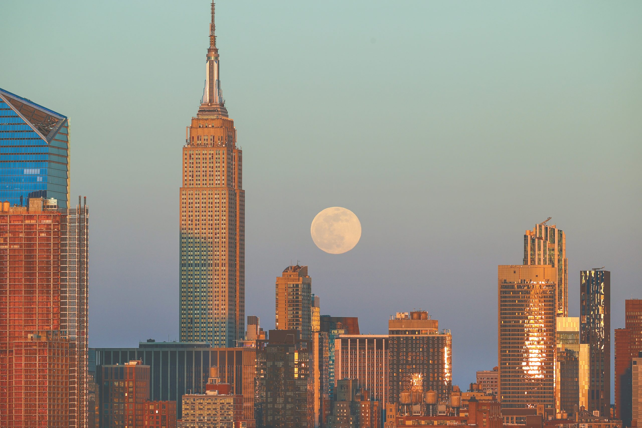 NEW YORK, USA - APRIL 26: Full moon rises behind Empire State Building during sunset in New York City, United States on April 26, 2021. (Photo by Tayfun Coskun/Anadolu Agency via Getty Images)