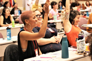 Young women's division joyfully participating in a Buddhist activity.