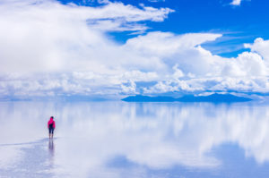 Person Standing On Salt Flat Against Sky