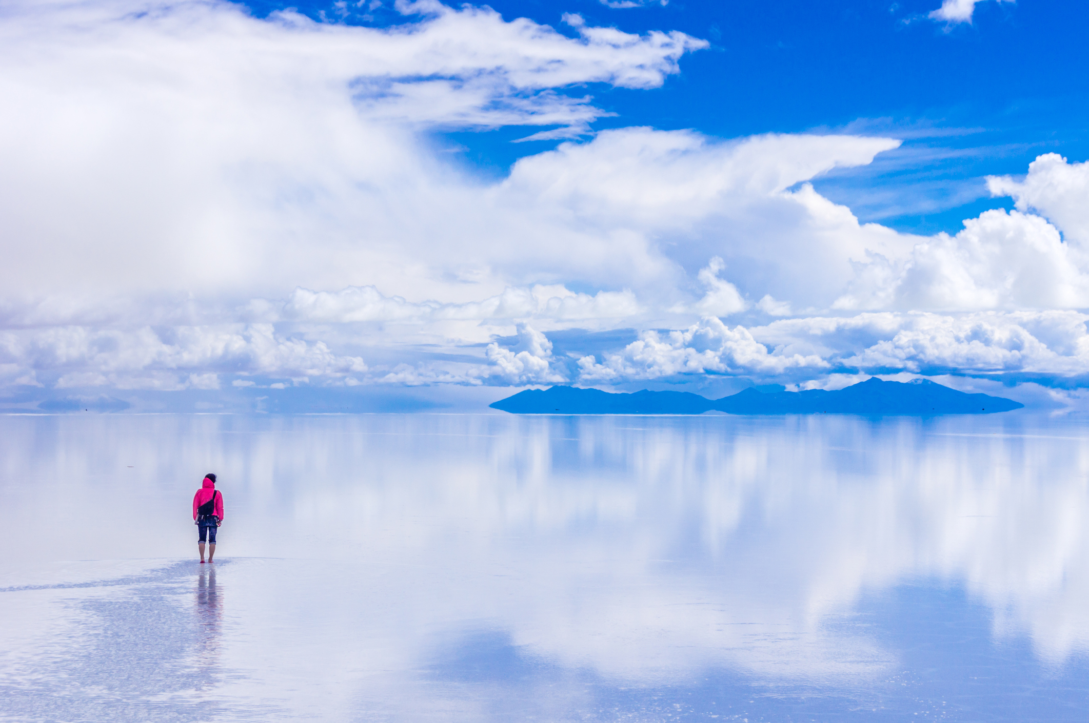 Person Standing On Salt Flat Against Sky