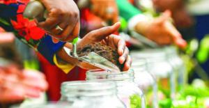 Soil is added to a jar during a soil collection ceremony during commemoration of the Tulsa race massacre centennial on May 31, 2021 in Tulsa, Oklahoma