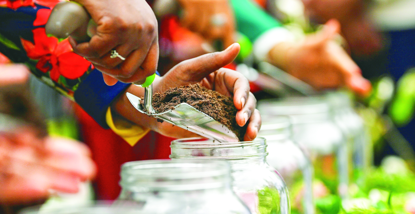 Soil is added to a jar during a soil collection ceremony during commemoration of the Tulsa race massacre centennial on May 31, 2021 in Tulsa, Oklahoma