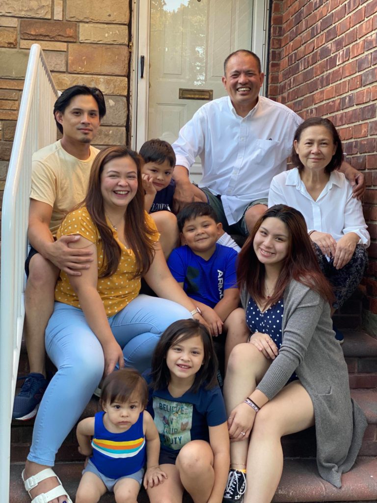 Rainer with his family in front of their new home in Long Island, N.Y., September 2021.