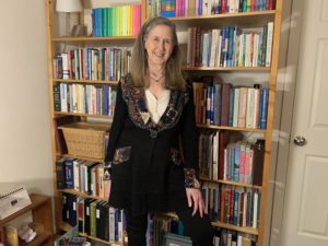 Susan Jacoby standing in front of her bookshelf